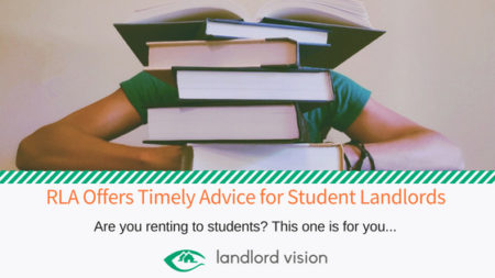 A student behind a pile of books