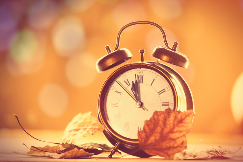 vintage alalrm clock on yellow background with bokeh