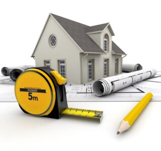 17851729 - a house on top of blueprints, a pencil and a tape measure