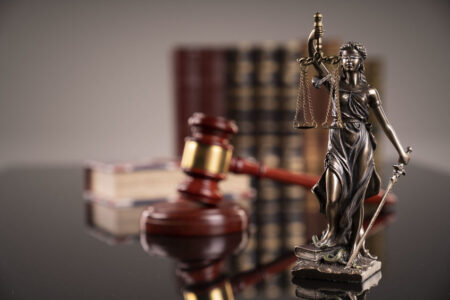 a small statute next to a gavel