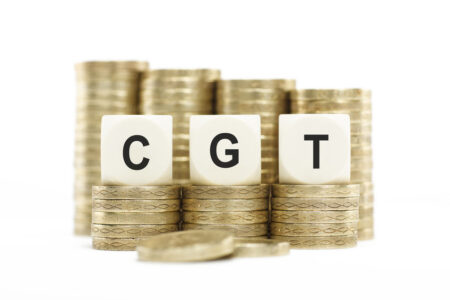 Financial tax planning concept. Letters CGT (Capital Gains Tax) on lettered dice. Taxation of growth and gains on investments, stocks and shares.