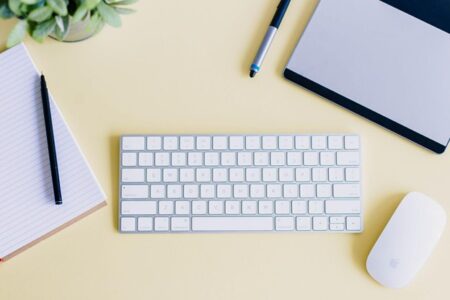 a keyboard and notepad on desk