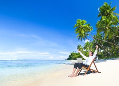 man sat on the beach in a suit