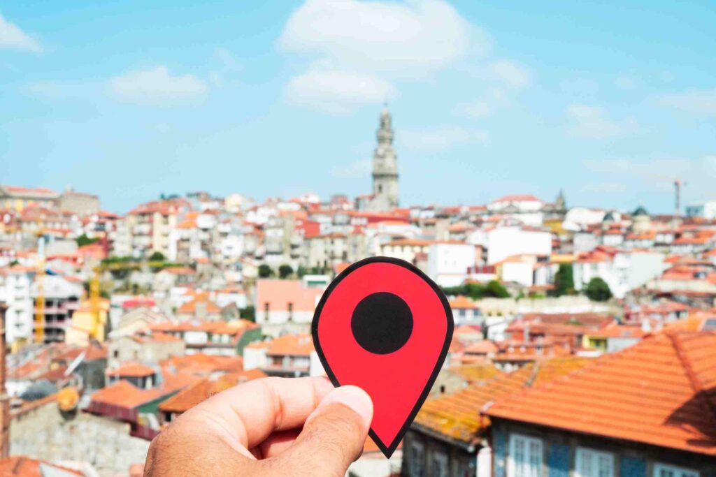 A place marker being held in front of a city scape