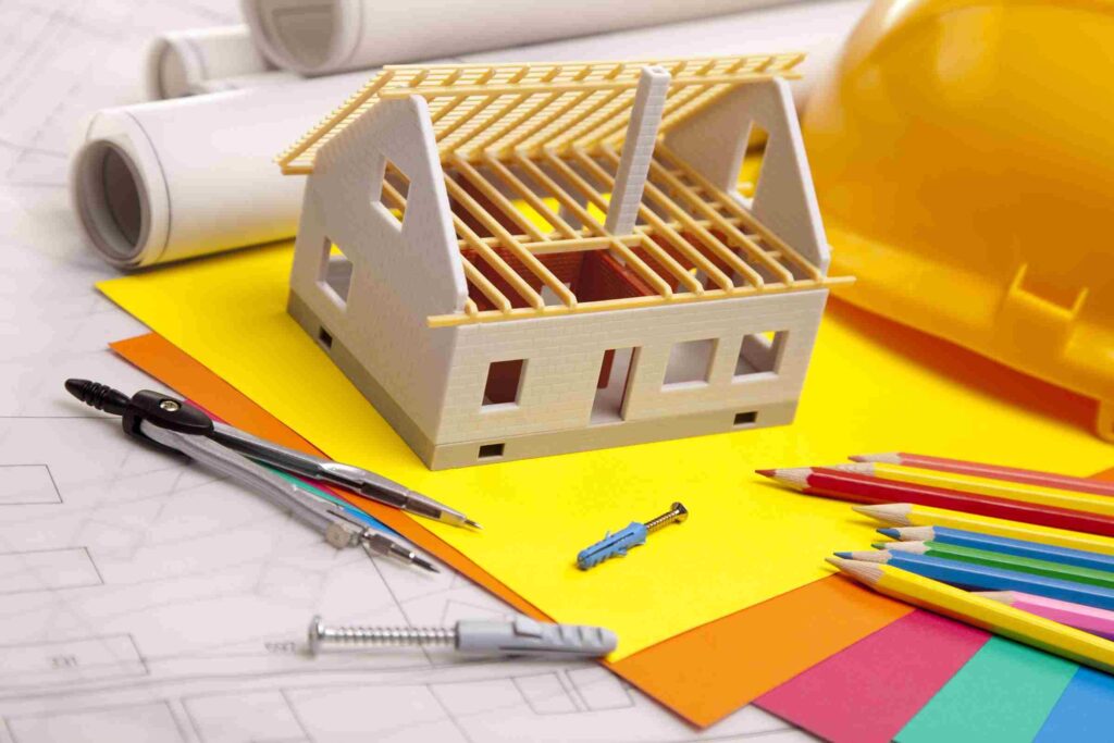Construction plans with helmet and drawing tools on blueprints