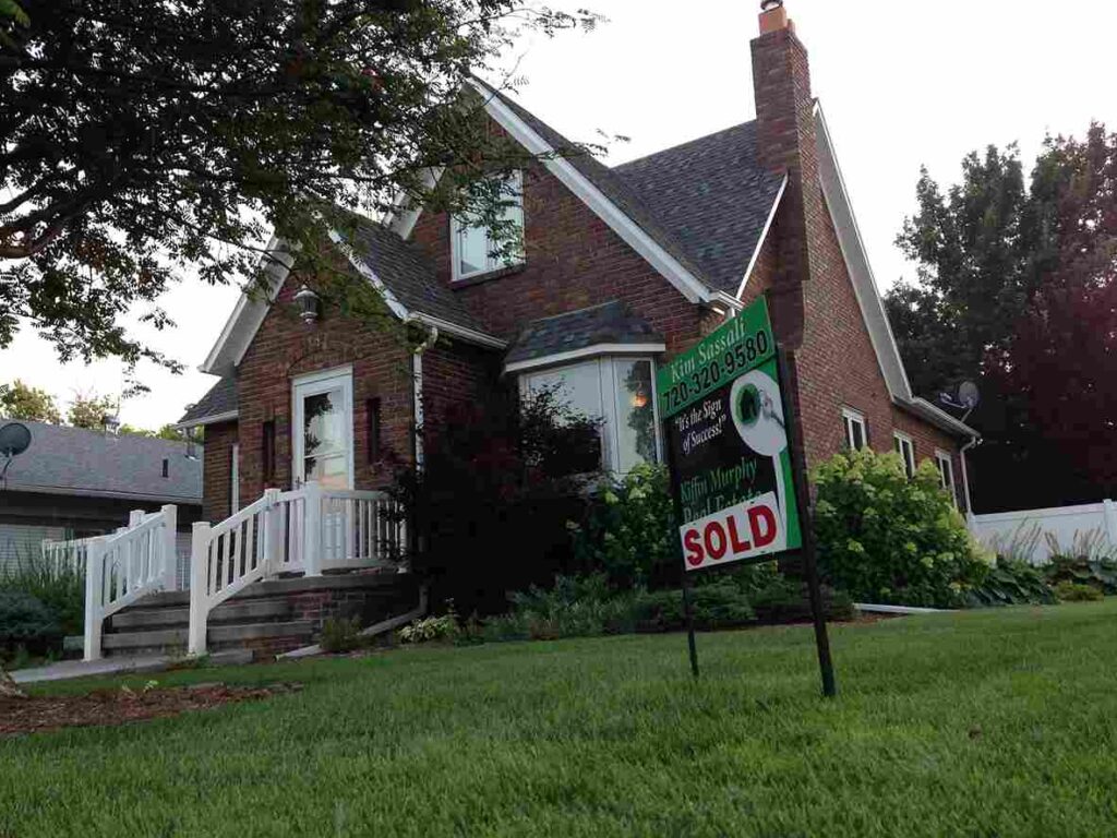 A house with a sold sign outside