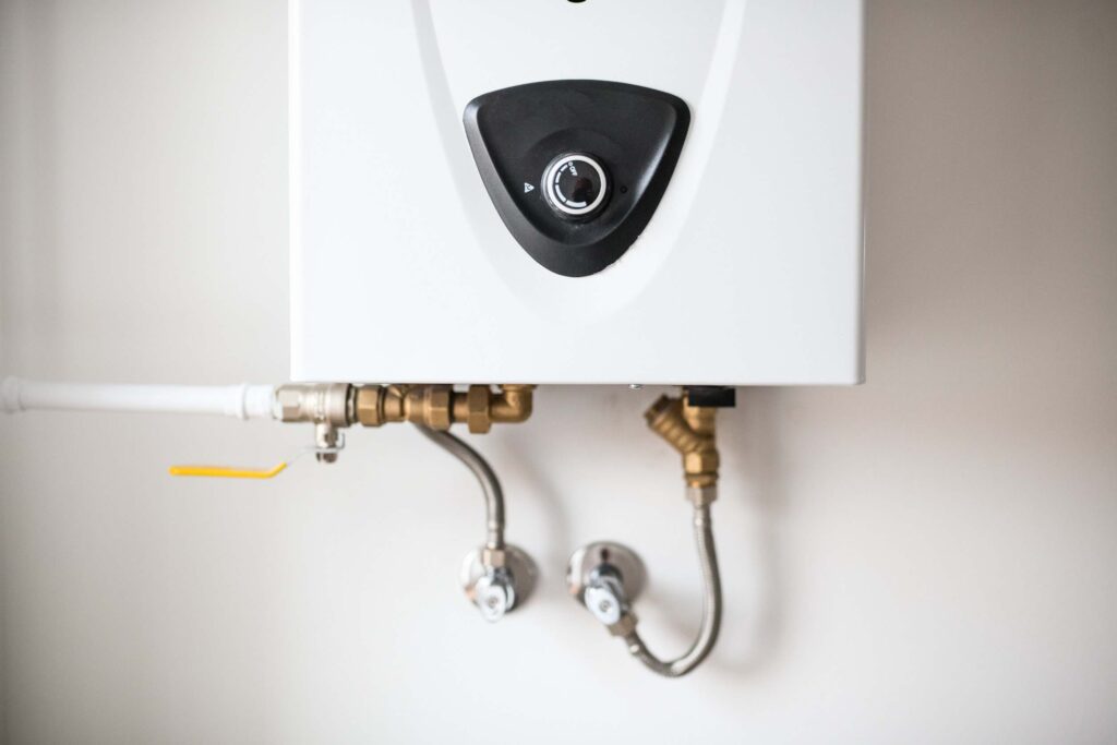 A gas combi boiler with pipes coming out of the bottom.