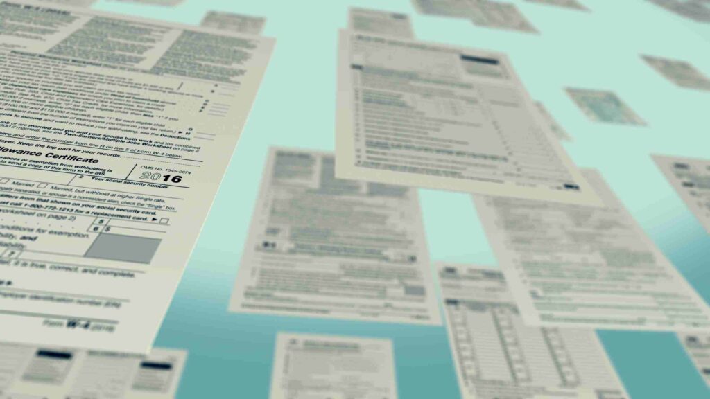 Self assessment tax return forms against a blue background.