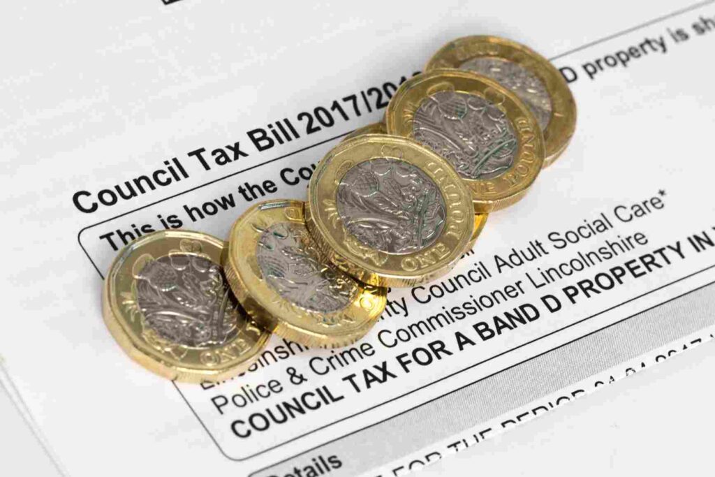 A stack of pound coins on a council tax bill.