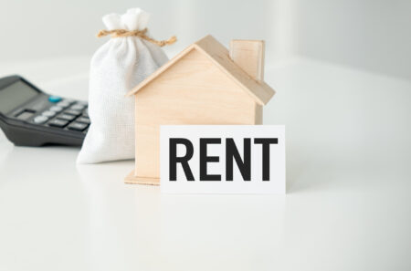 Rent text with house model. Property insurance. Business real estate. Money management.