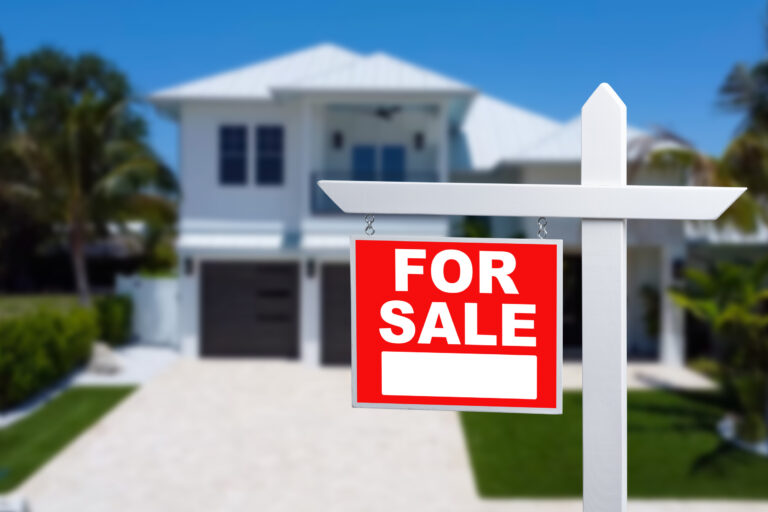 Home For Sale Real Estate Sign and Beautiful New House
